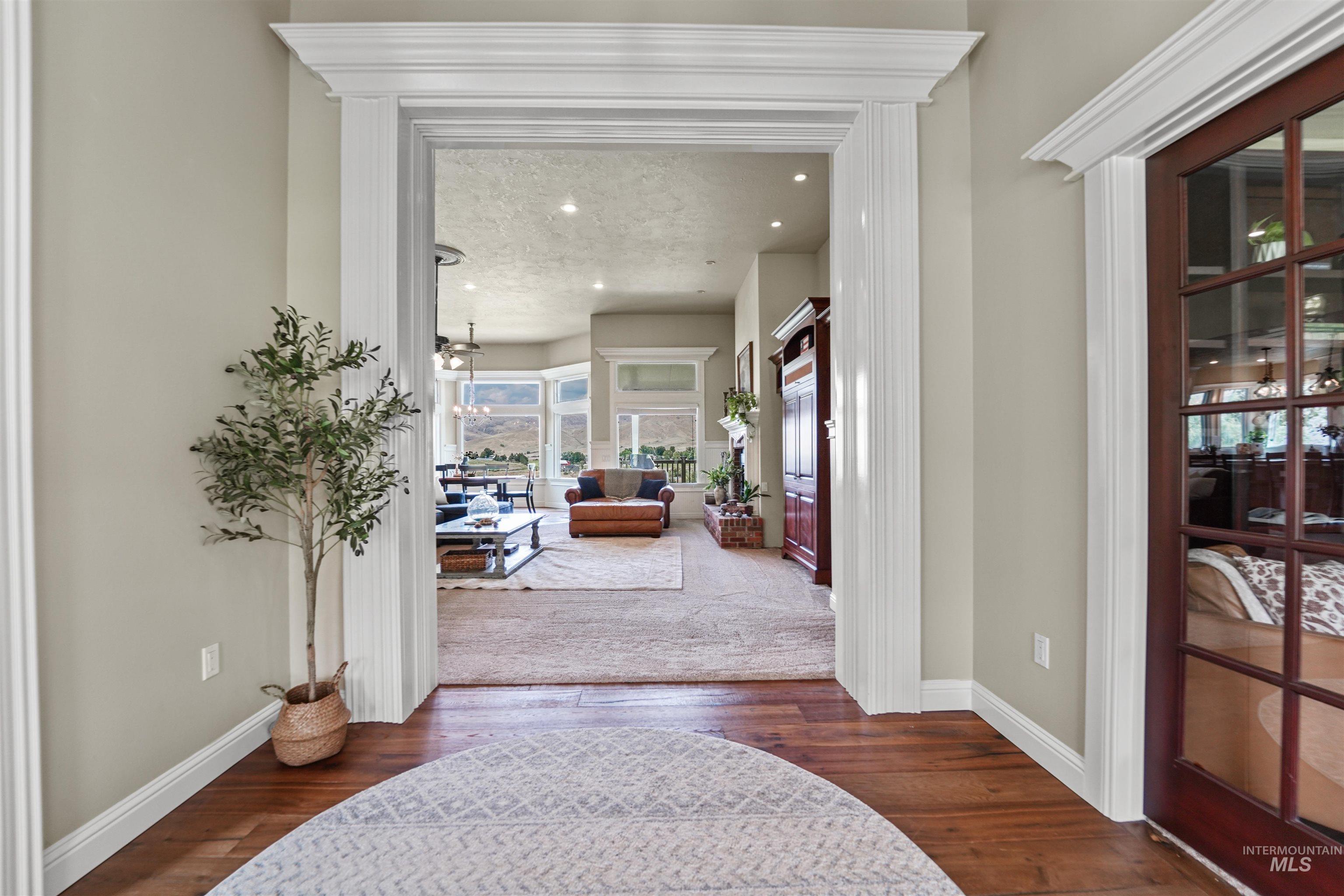 Entryway with wood-type flooring and recessed lighting