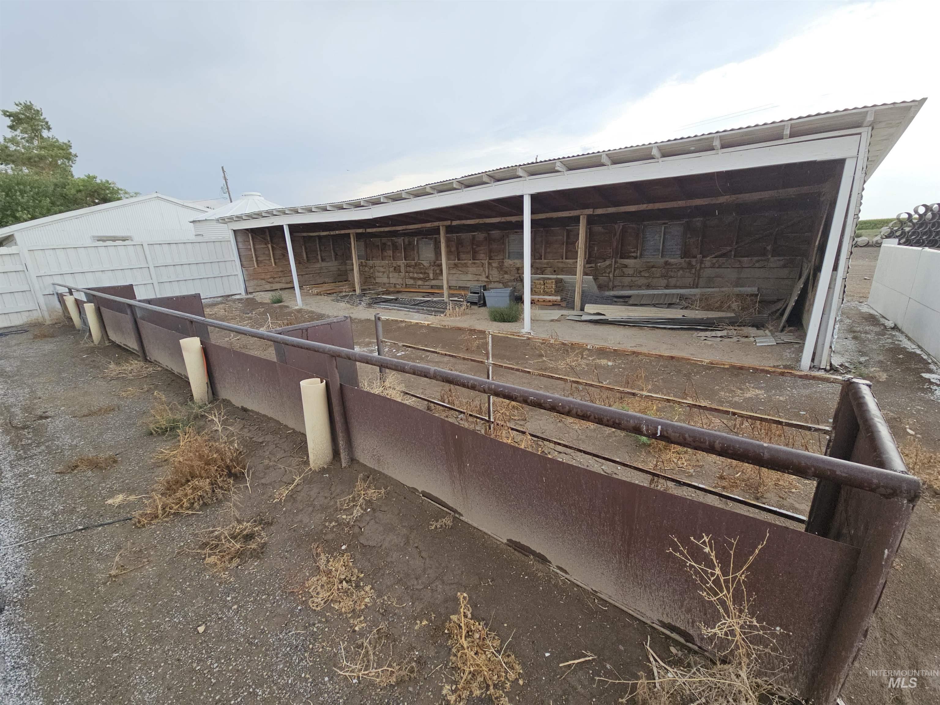 Back of house with an exterior structure, an outbuilding, and a metal roof