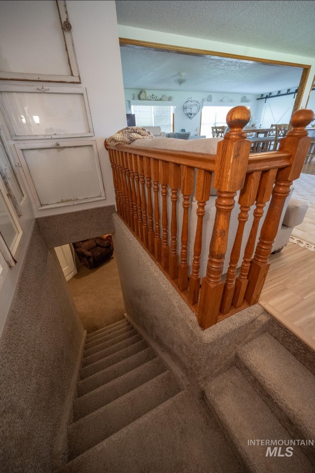 Stairway featuring a textured ceiling