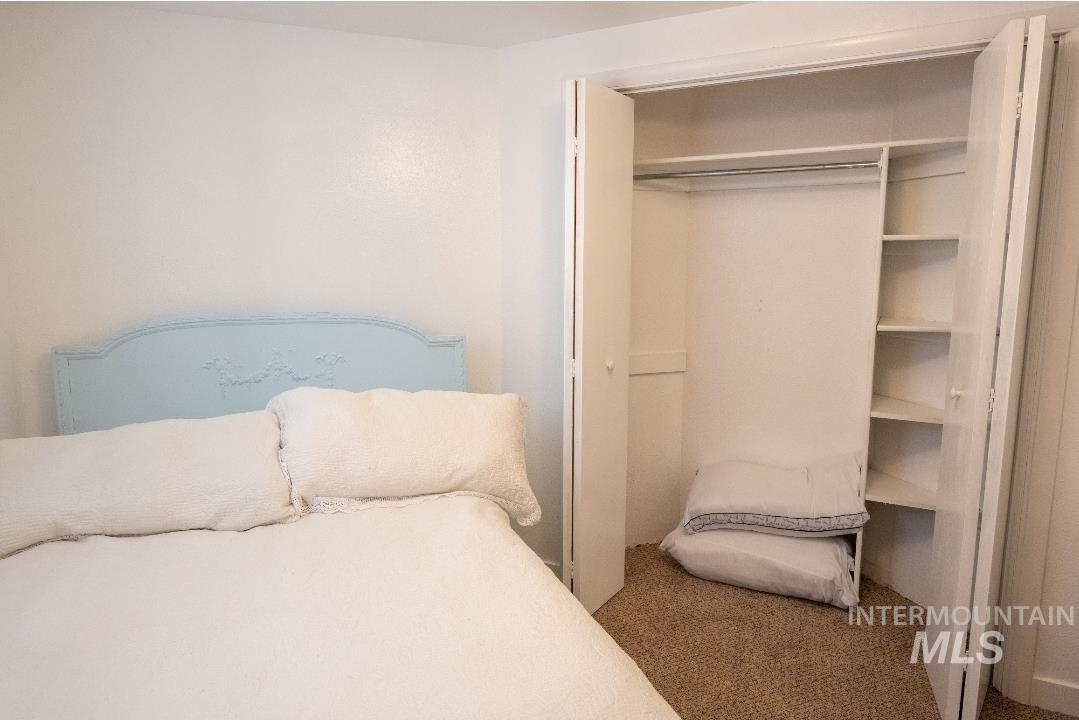 Carpeted bedroom with a closet