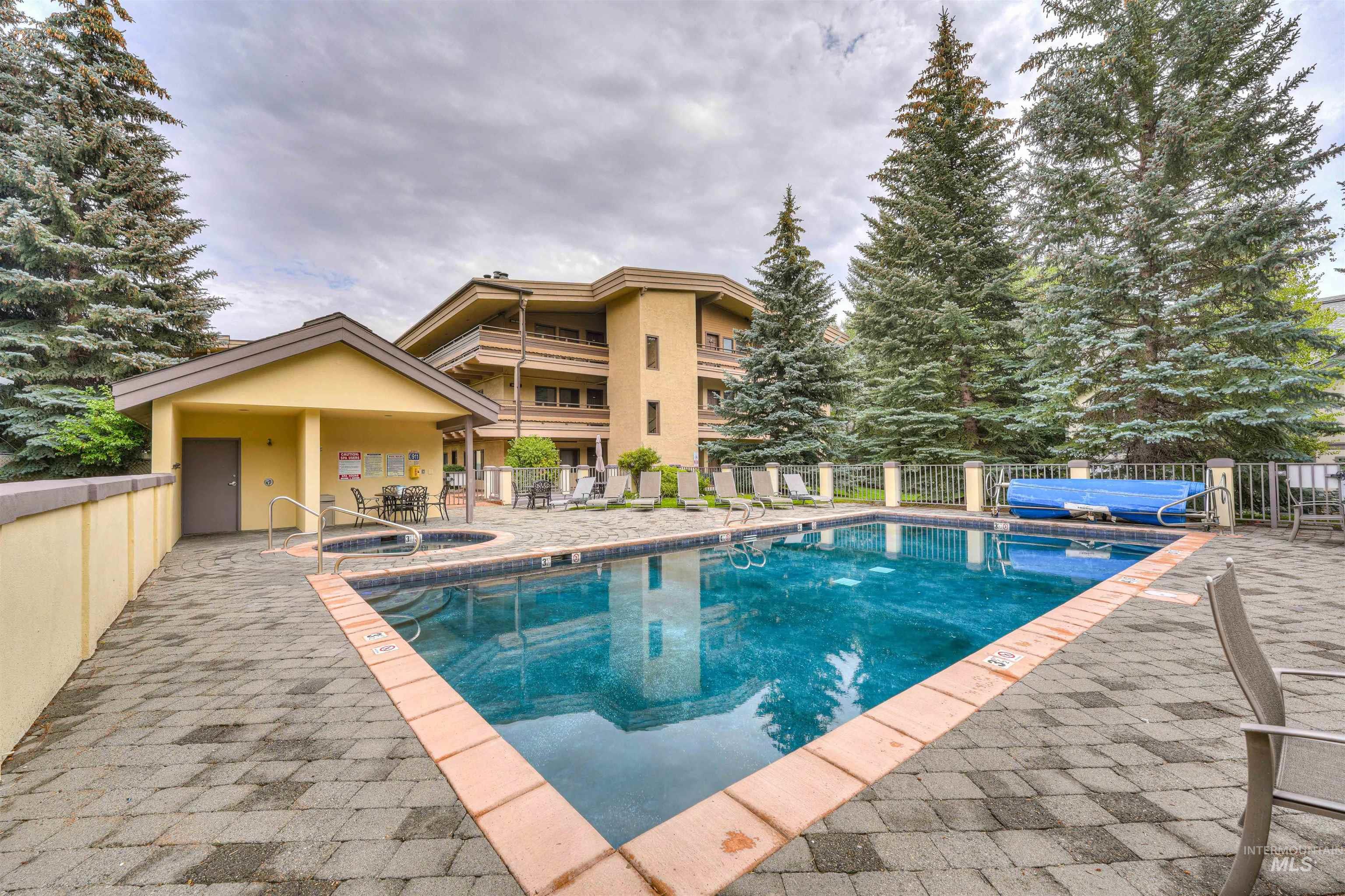 Community pool with a hot tub and a patio area
