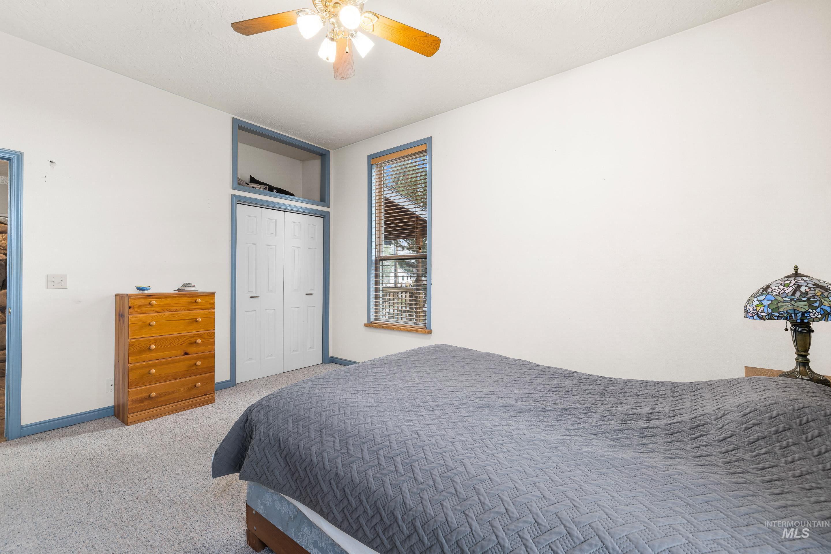 Bedroom featuring a closet, carpet flooring, and ceiling fan