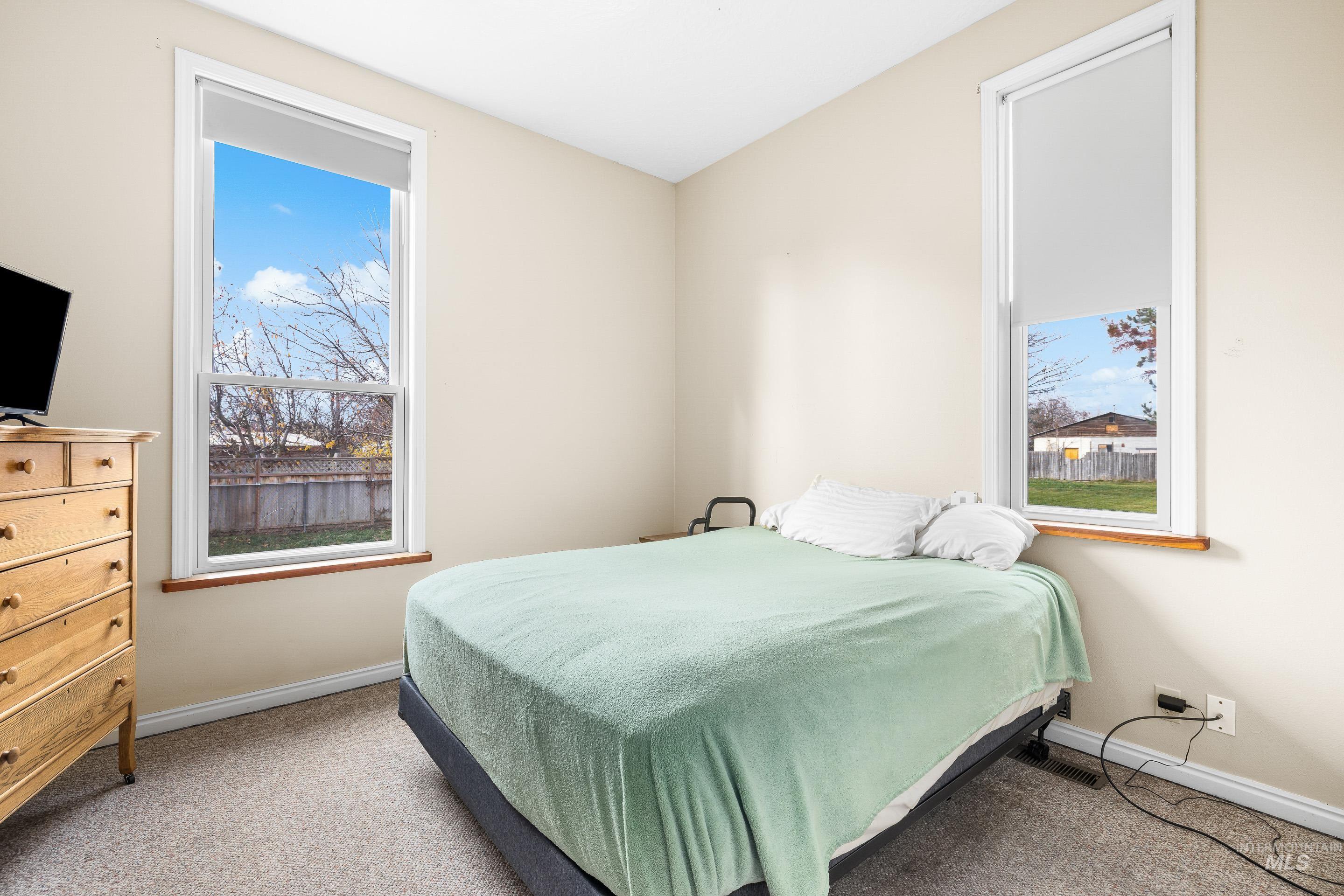 Carpeted bedroom featuring baseboards