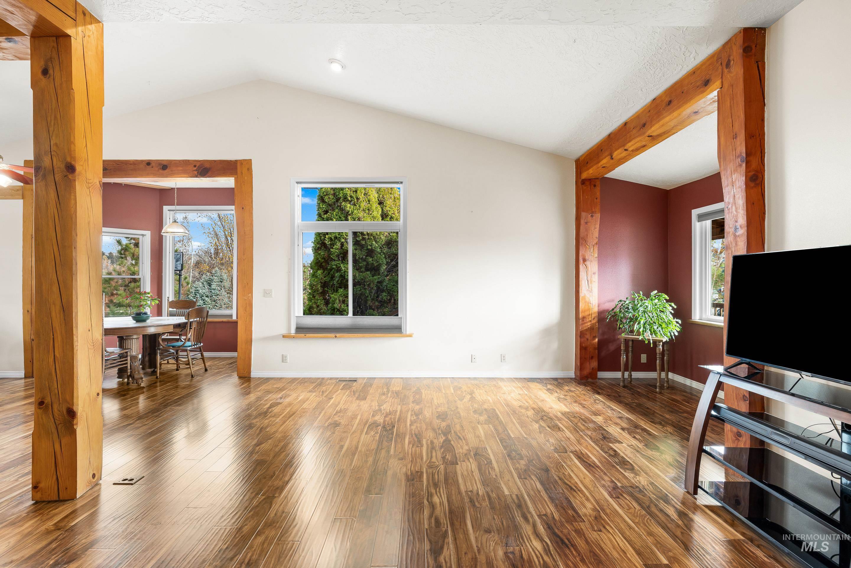 Living room with lofted ceiling and wood finished floors