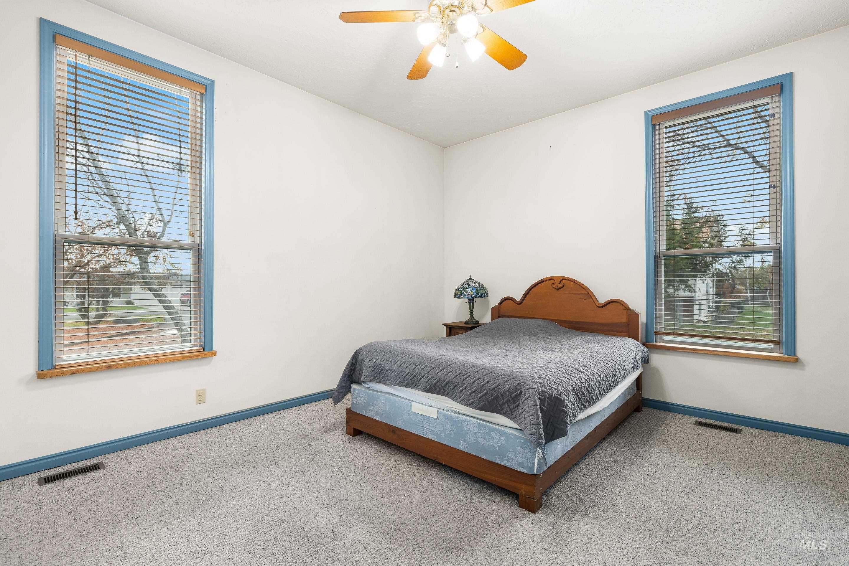 Bedroom featuring ceiling fan and carpet floors