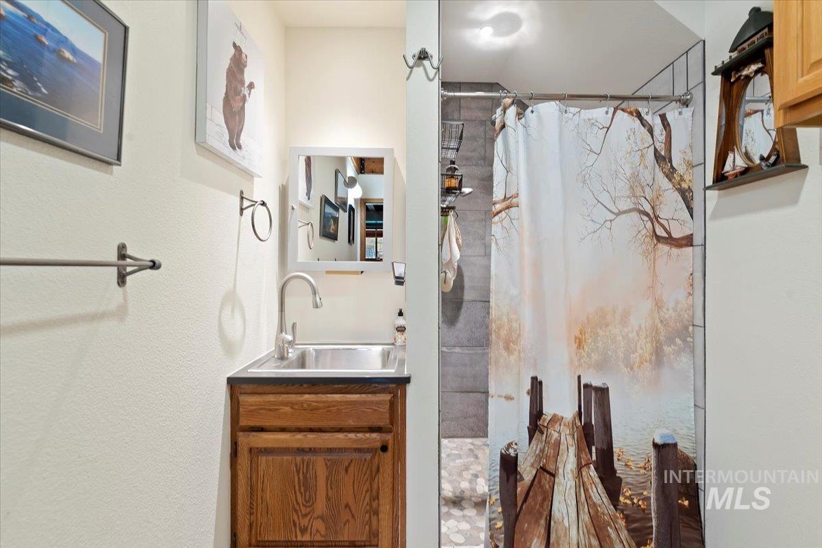 Bathroom featuring a shower stall and vanity