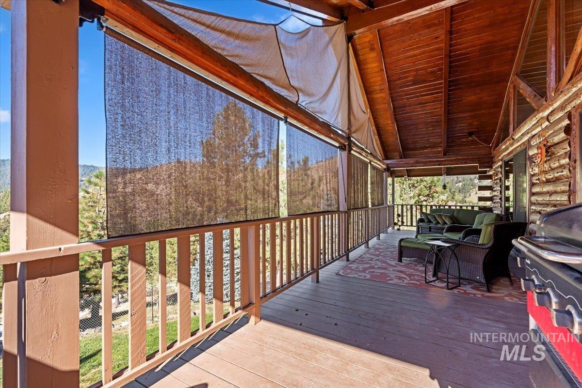 Deck featuring grilling area and an outdoor hangout area