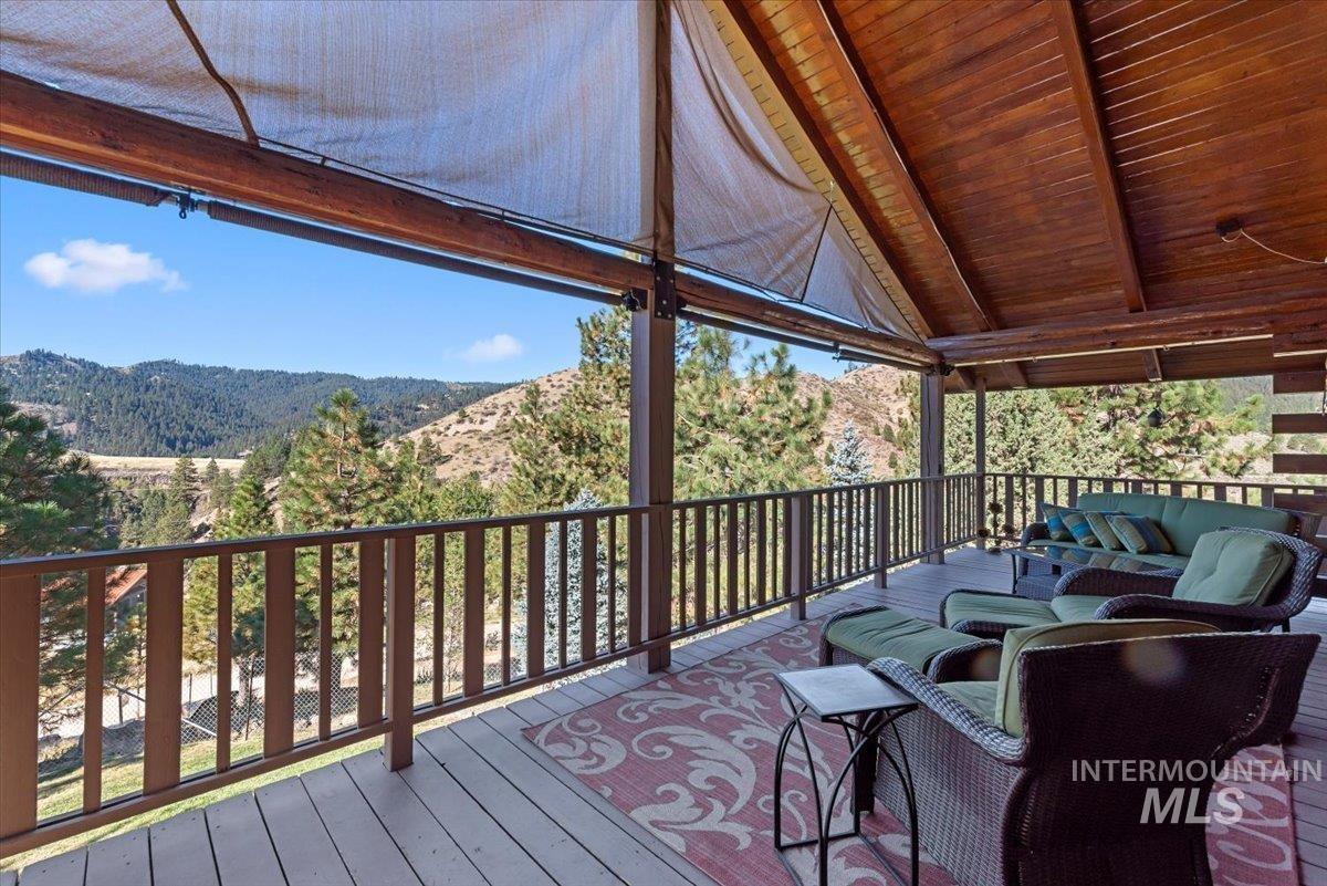 Wooden terrace featuring an outdoor hangout area and a mountain view