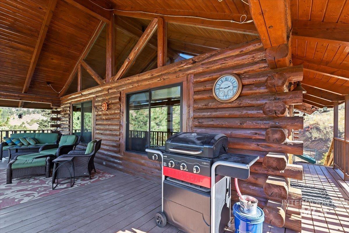 Wooden terrace featuring outdoor lounge area and area for grilling