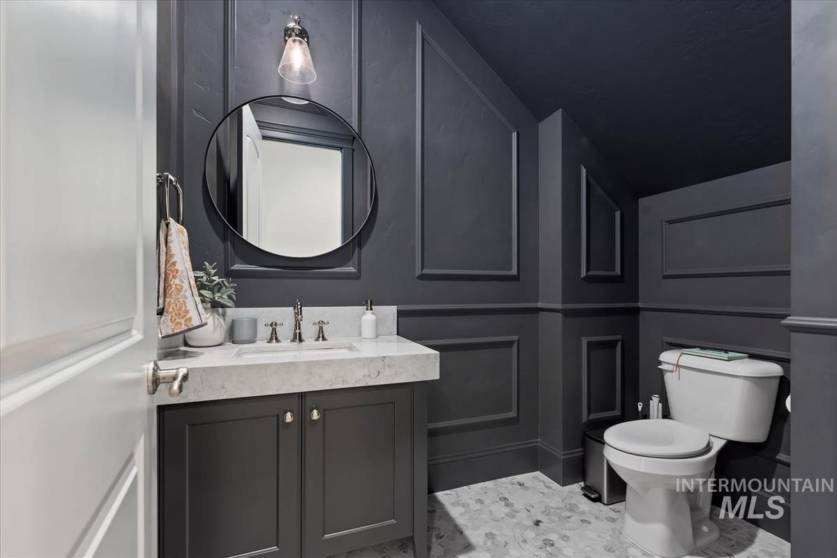 Bathroom featuring vanity and a decorative wall