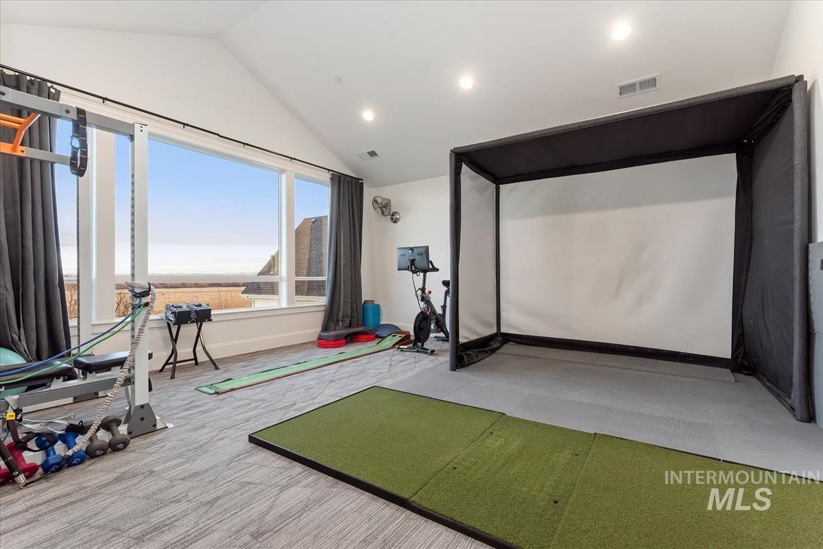Exercise area with vaulted ceiling, recessed lighting, golf simulator, and light carpet