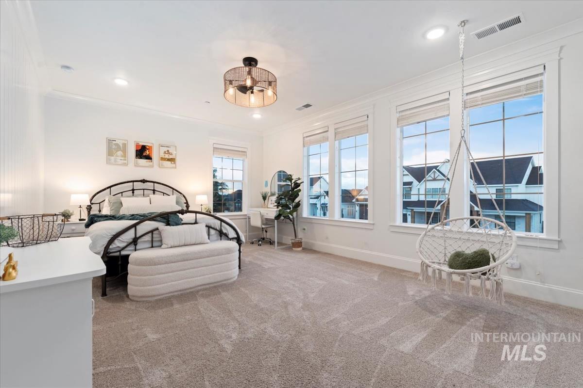 Bedroom with light carpet, ornamental molding, and recessed lighting
