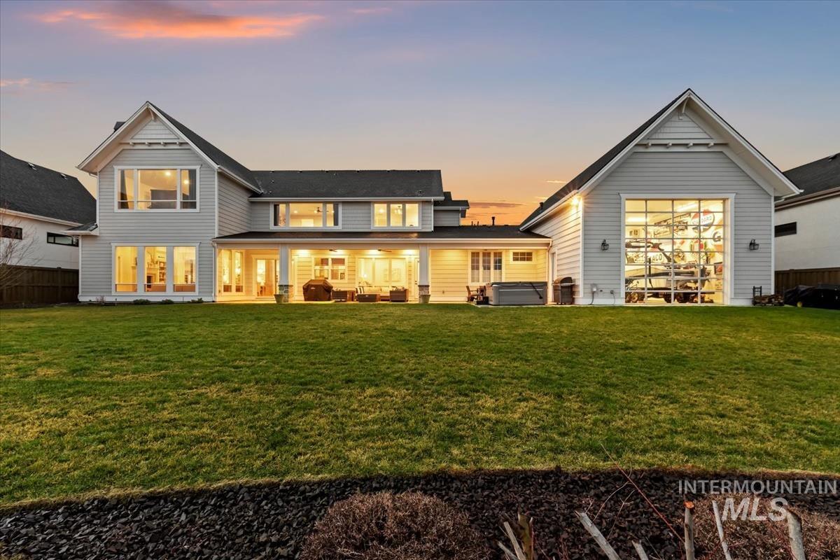 Back of property with a patio area and a hot tub