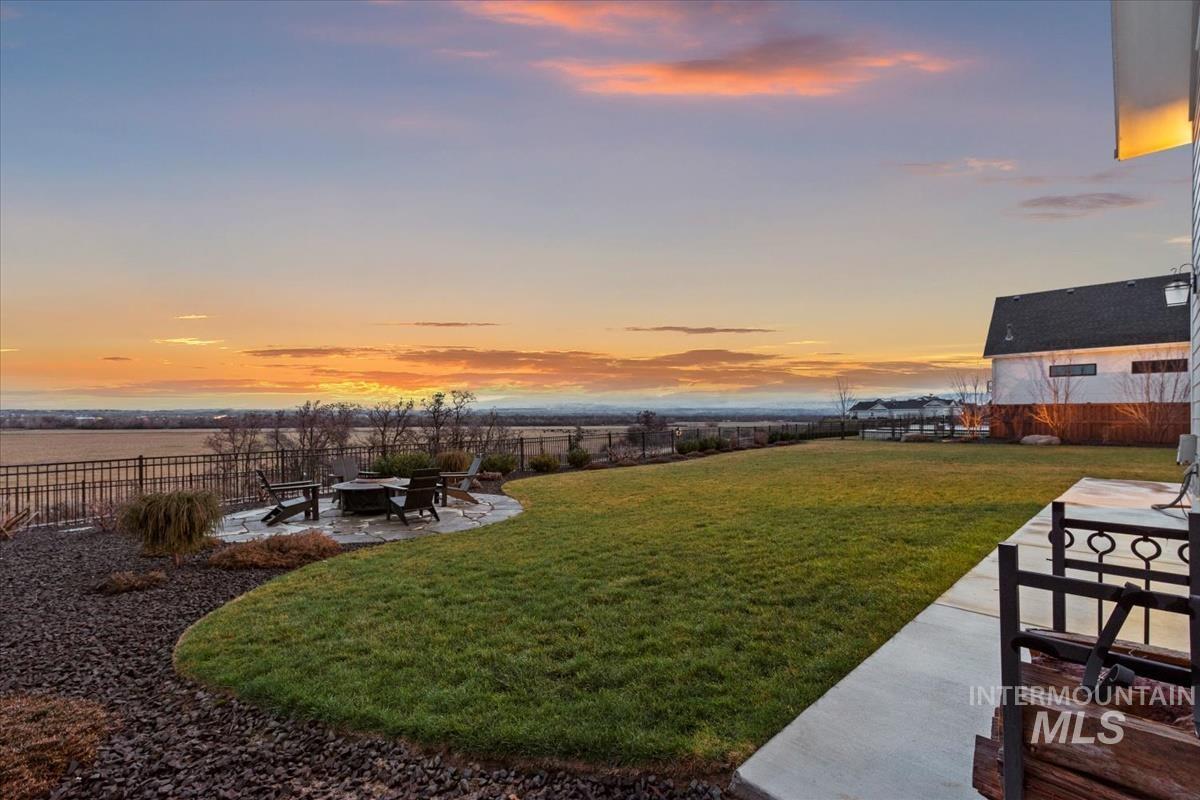 Fenced backyard with a patio area and a fire pit