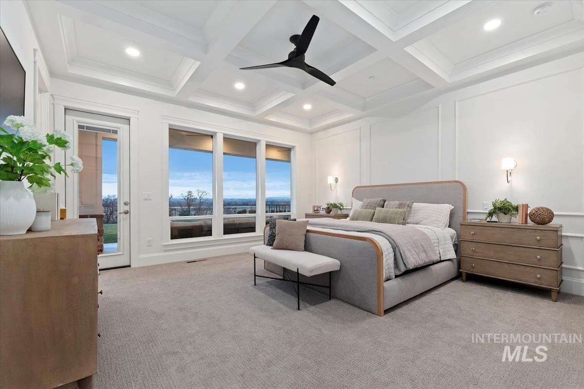 Bedroom with light colored carpet, access to outside, coffered ceiling, ceiling fan, and a decorative wall