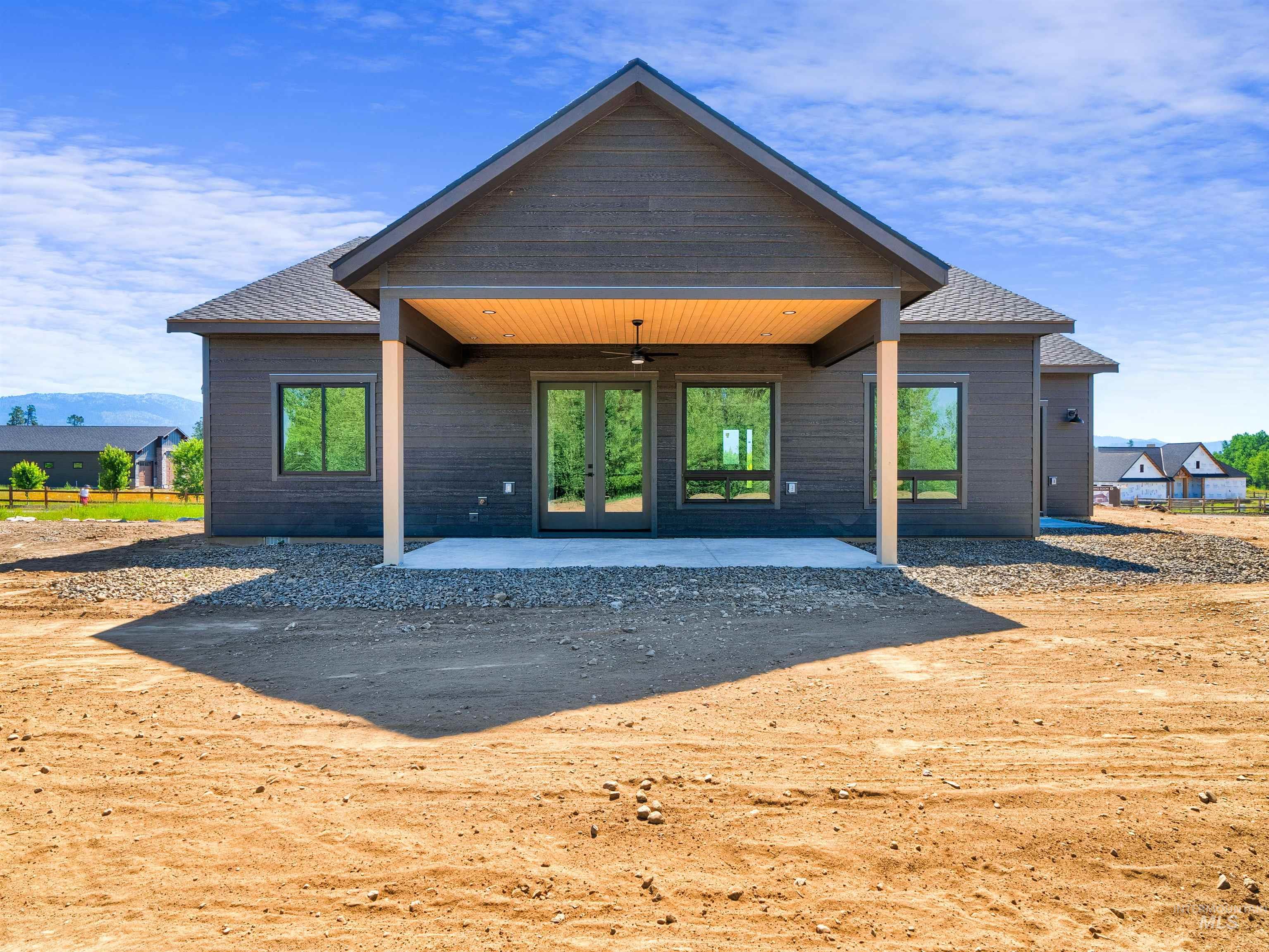 Rear view of house featuring a patio area, ceiling fan, and french doors