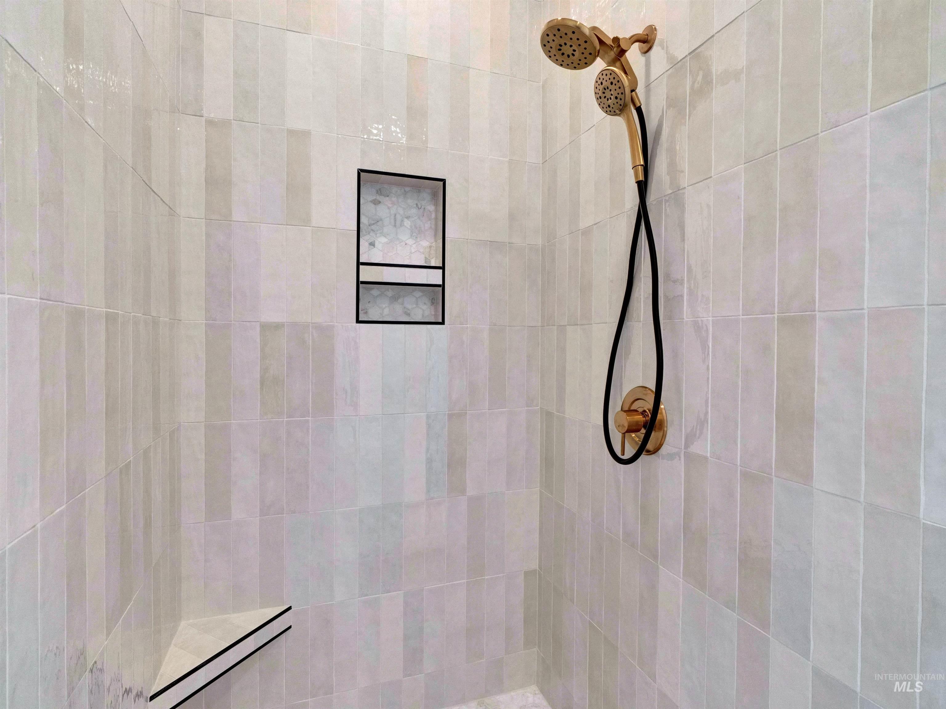 Full bath featuring tiled shower