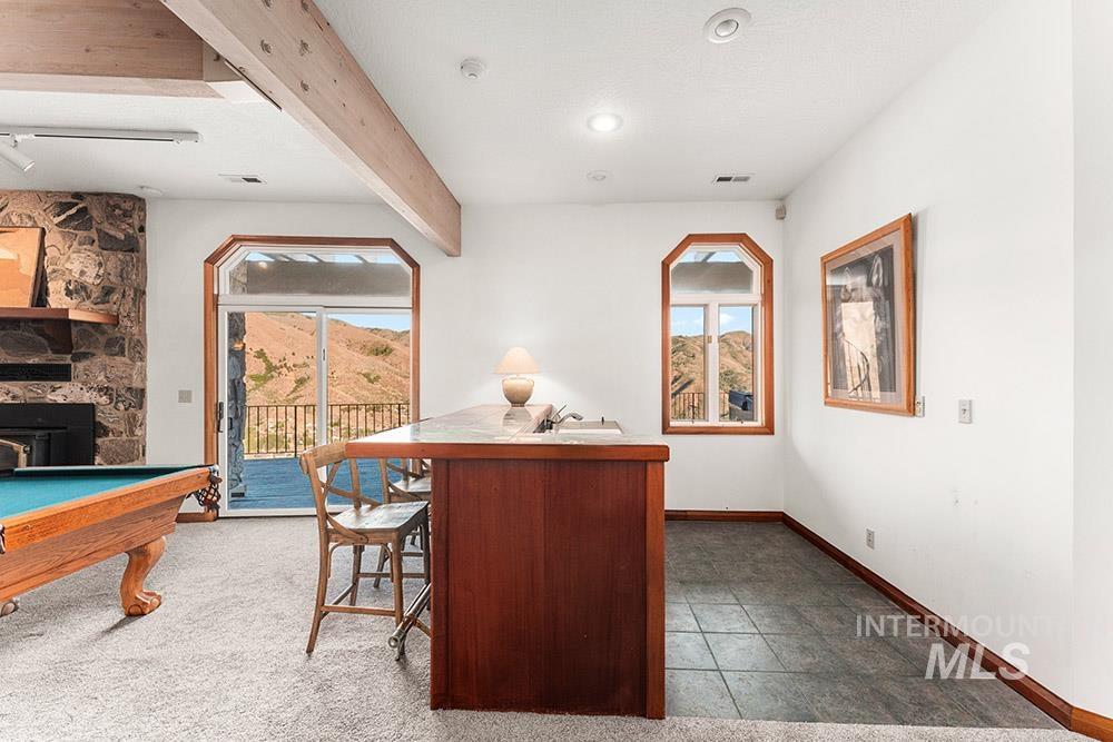 Bar area featuring beam ceiling and recessed lighting