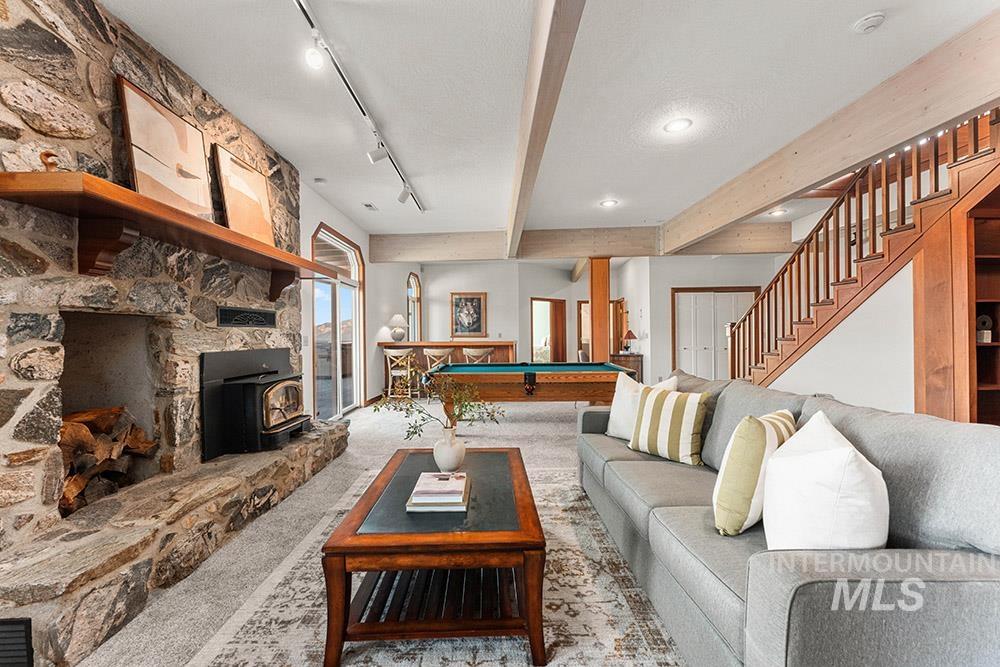 Living area featuring carpet, a wood stove, billiards, beamed ceiling, and recessed lighting