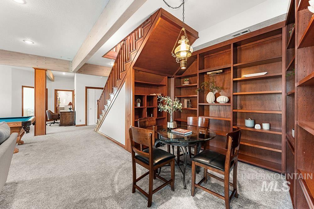 Dining room featuring carpet flooring, beamed ceiling, pool table, stairway, and recessed lighting