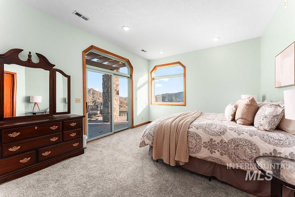 Bedroom featuring light colored carpet, access to outside, and recessed lighting
