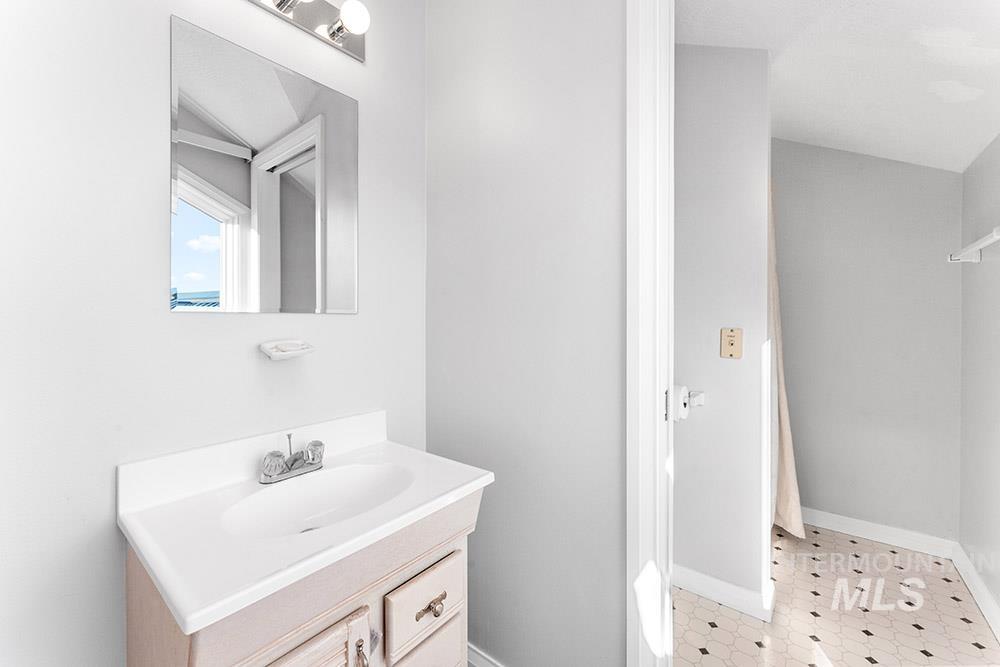 Bathroom featuring vanity and tile patterned floors