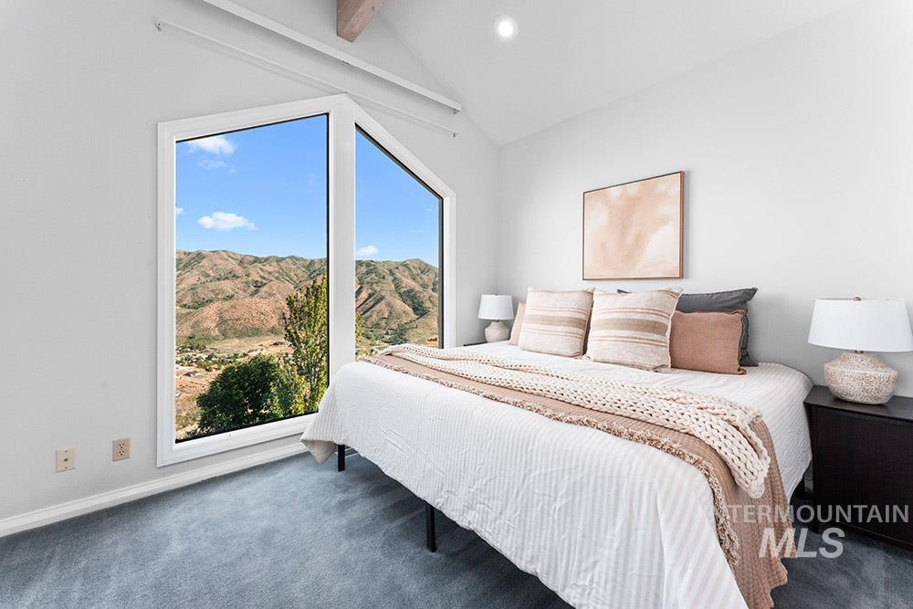 Carpeted bedroom featuring multiple windows, a mountain view, and recessed lighting