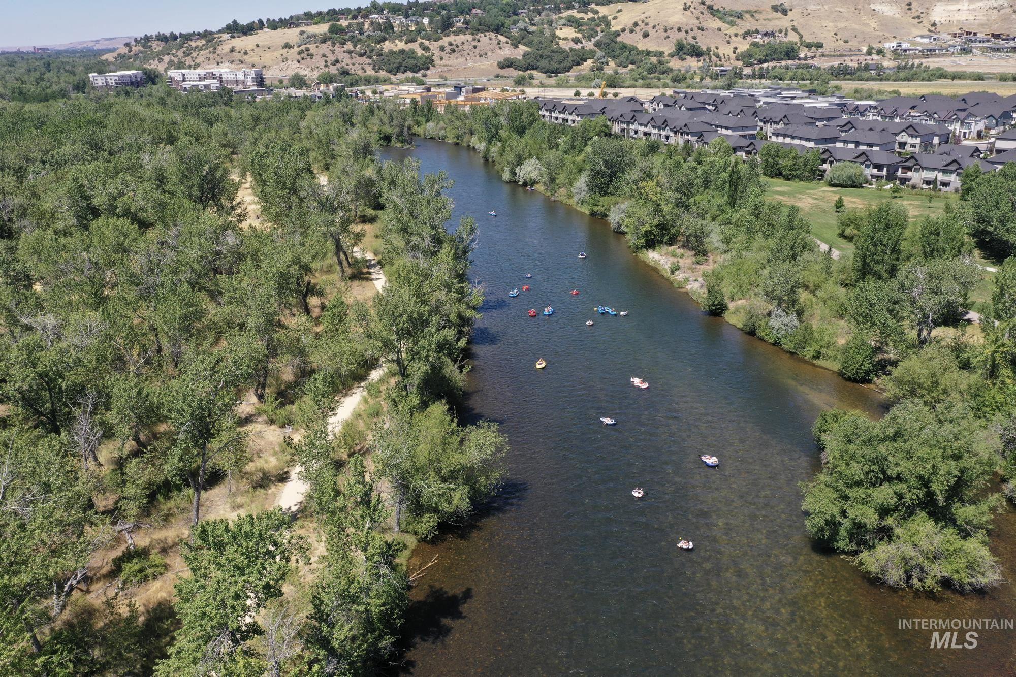 Aerial overview of property's location near the beautiful Boise River with summertime river floaters.