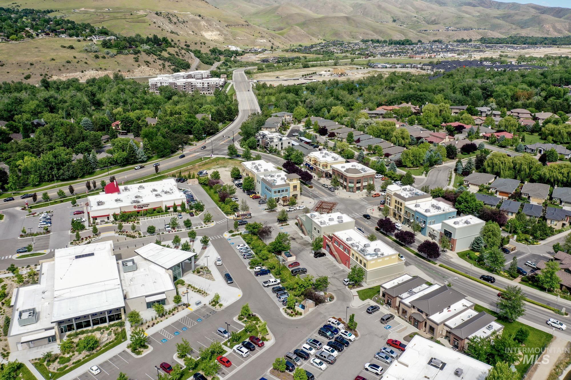 Aerial view of nearby Bown Crossing with shops, restaurants, coffee shops, & a branch of the Boise Library! Also shows a broad expanse of the beautiful Boise foothills.