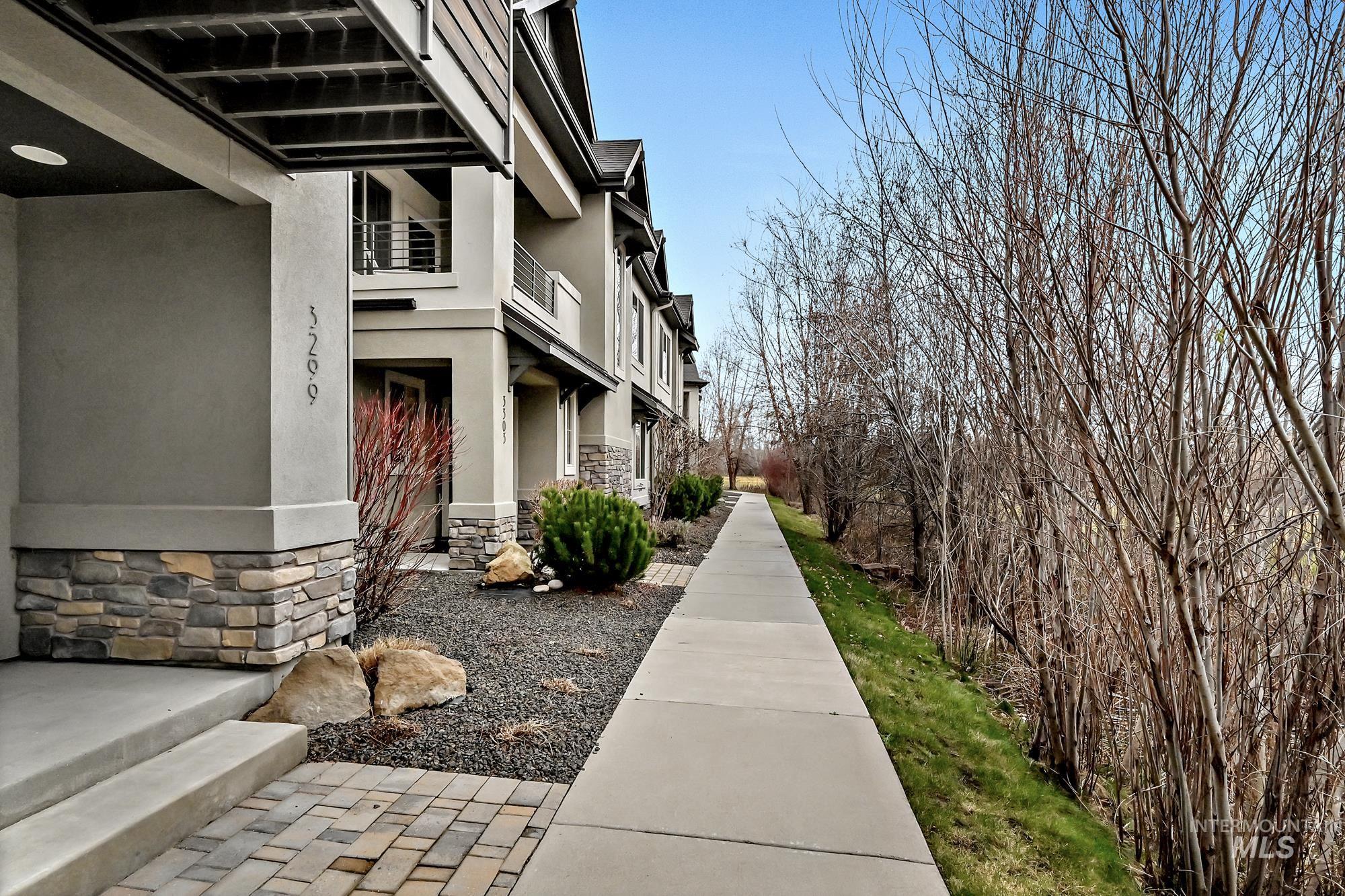 View of your walk along the private tree-lined sidewalk to your covered entry.