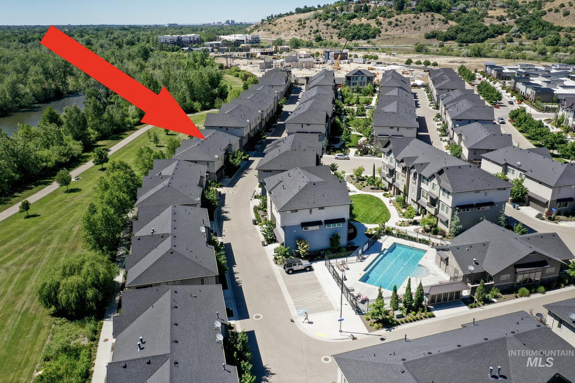 Aerial view which shows the townhome in relation to the Boise Greenbelt and the community pool.