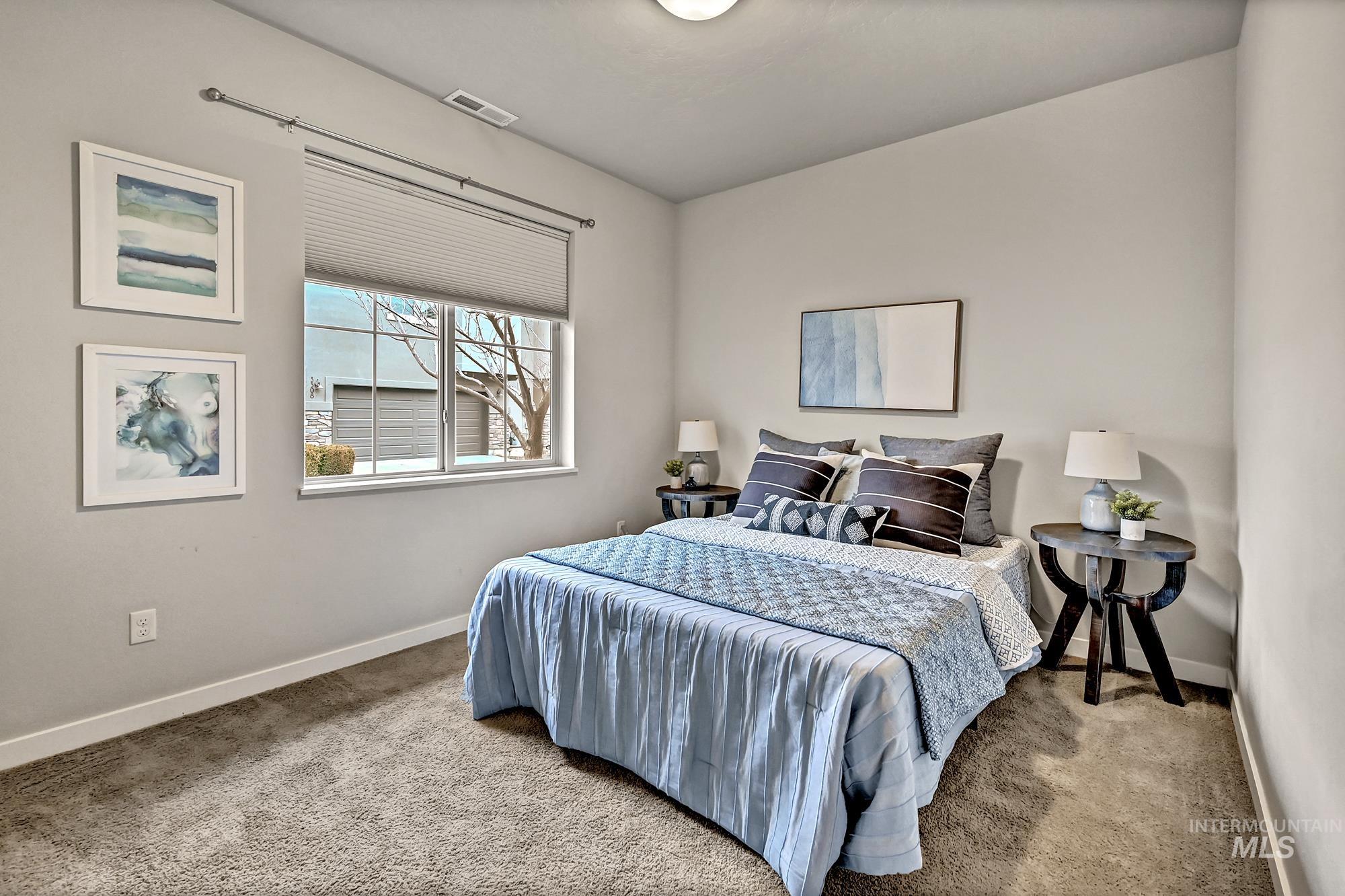 Carpeted bedroom featuring a large window