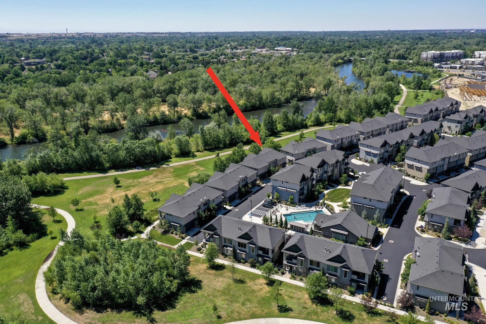 Aerial view of property and surrounding area looking west and featuring the Boise River and the property's location in relation to it (close!)