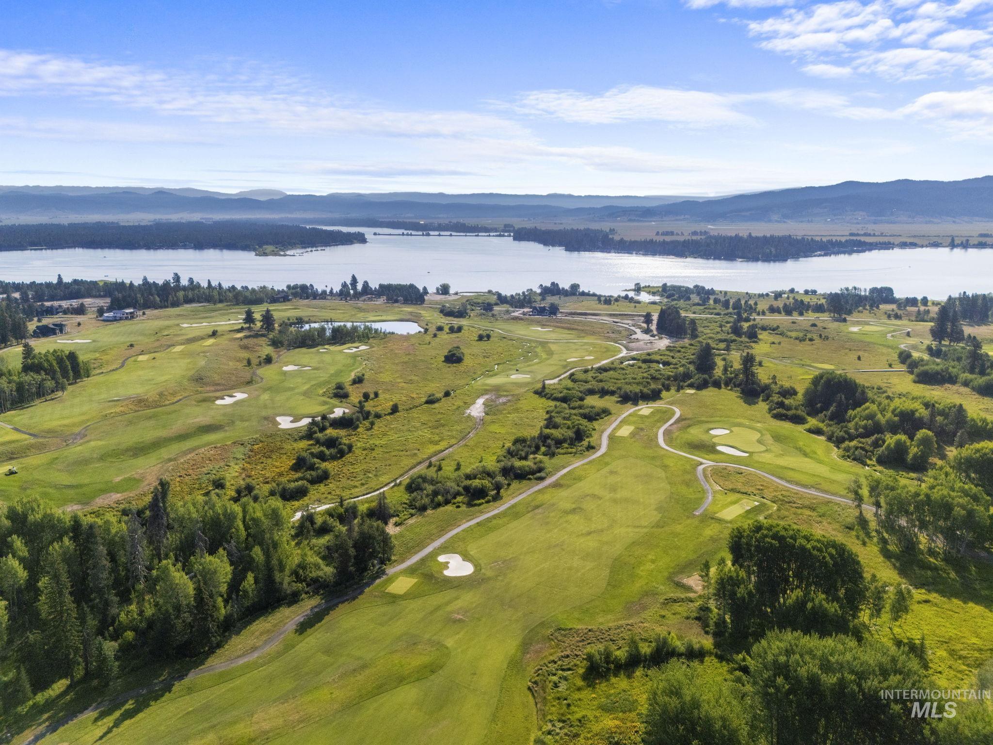 Aerial view of property's location with a water and mountain view and a golf club