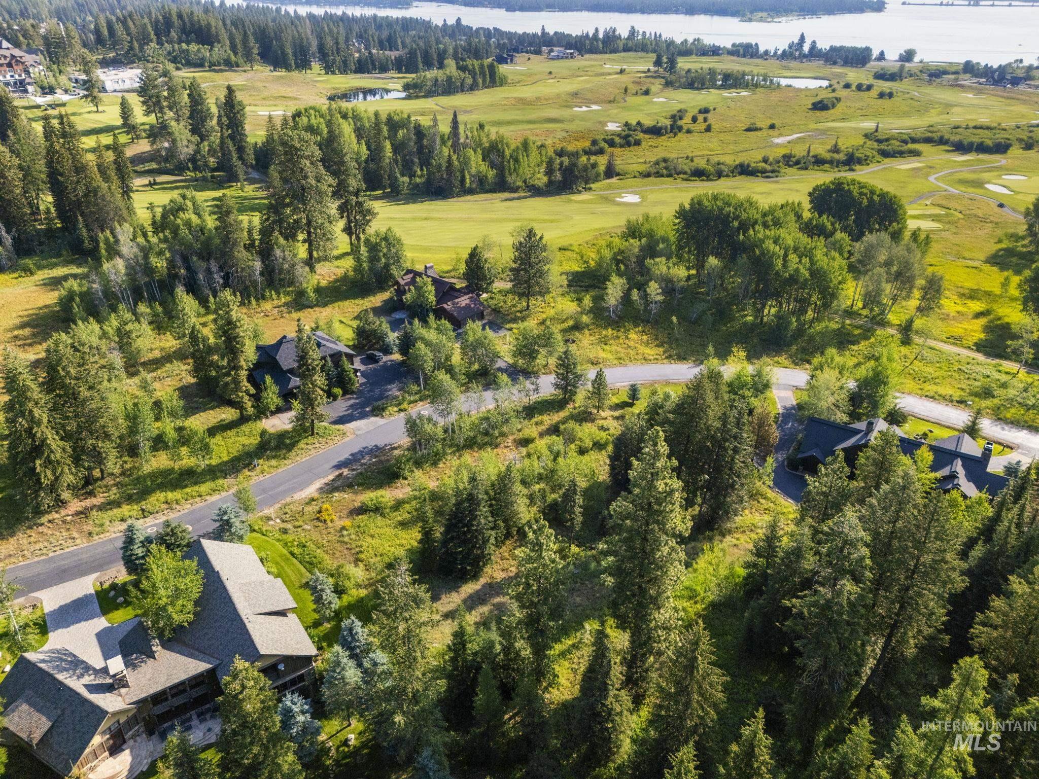 Aerial view of property's location with a nearby body of water and a local golf course