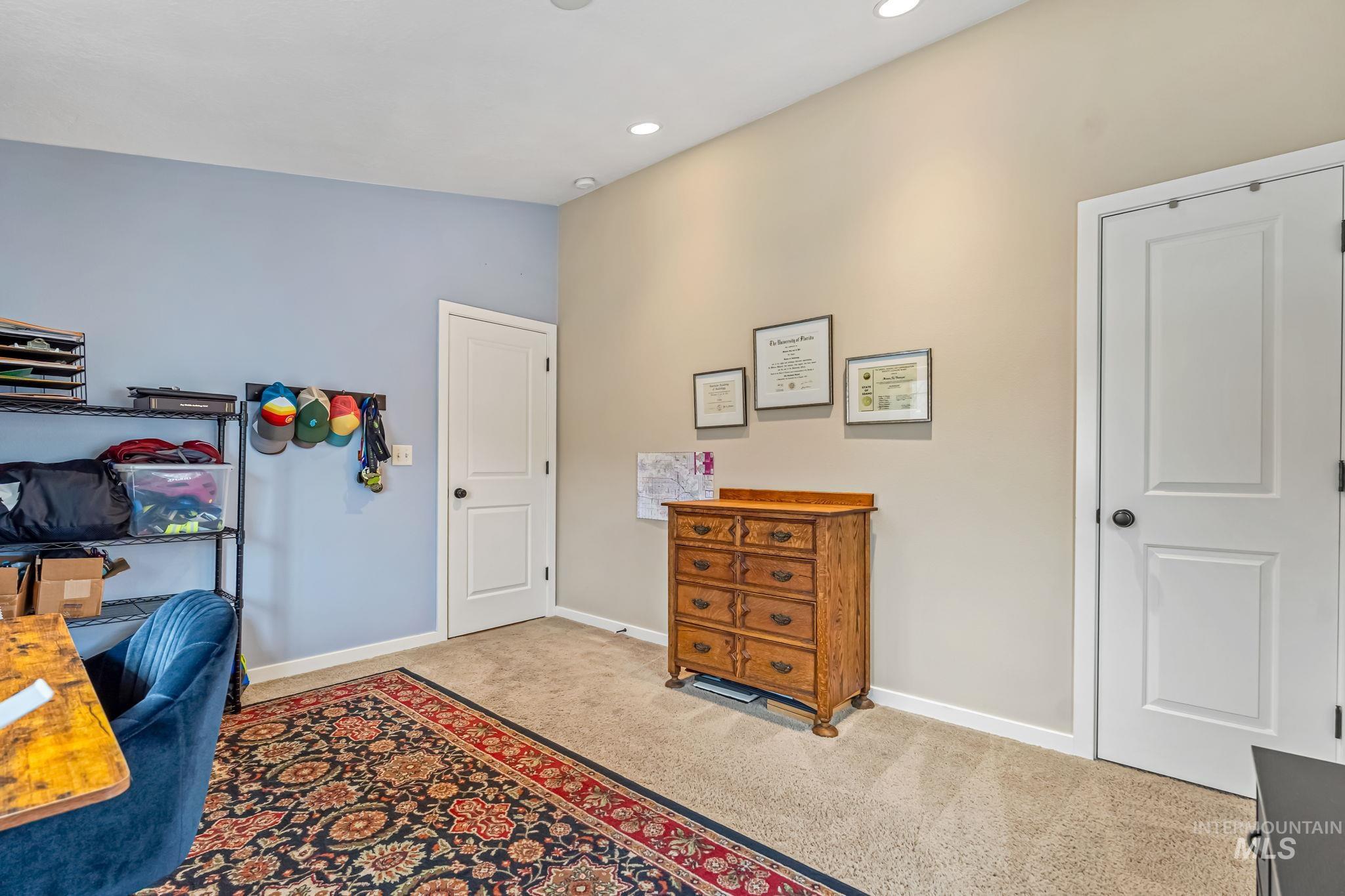 Office area or bedroom with recessed lighting and carpet