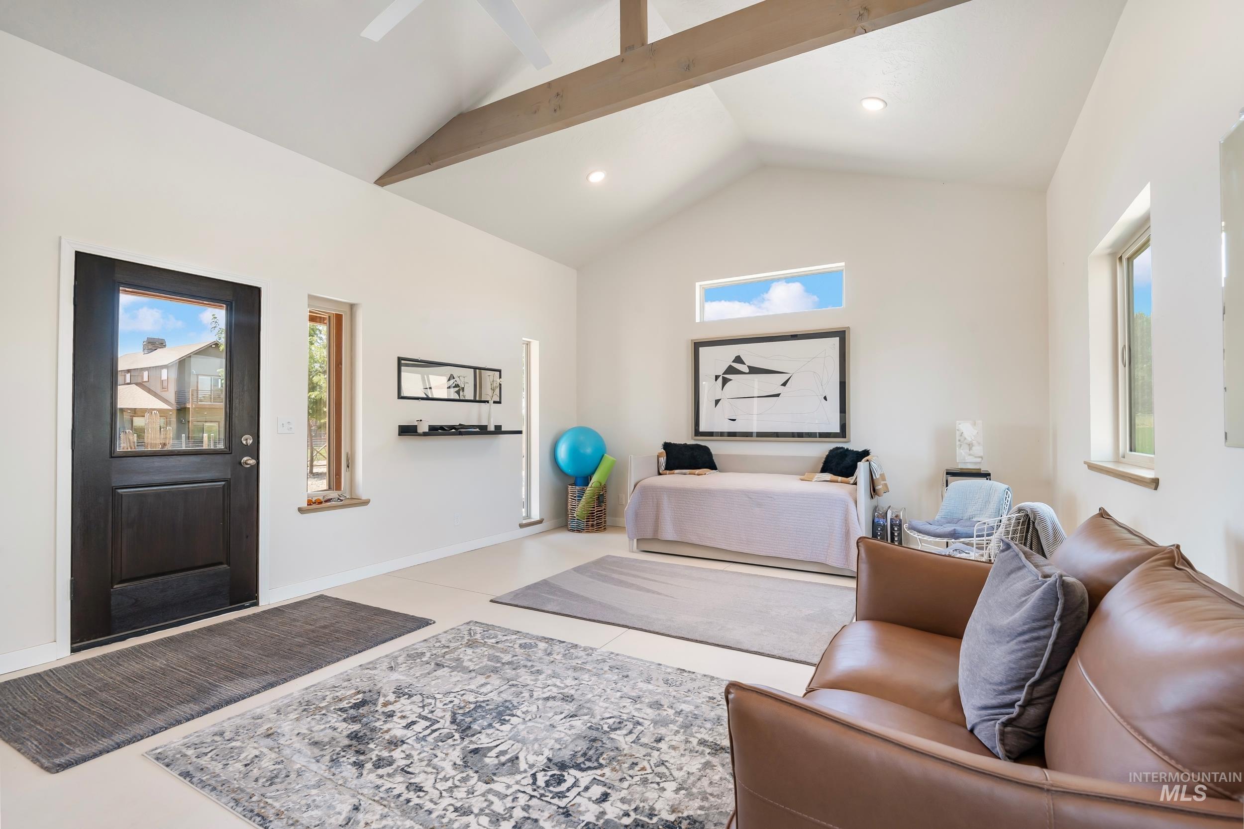 Entryway with high vaulted ceiling, recessed lighting, and beamed ceiling