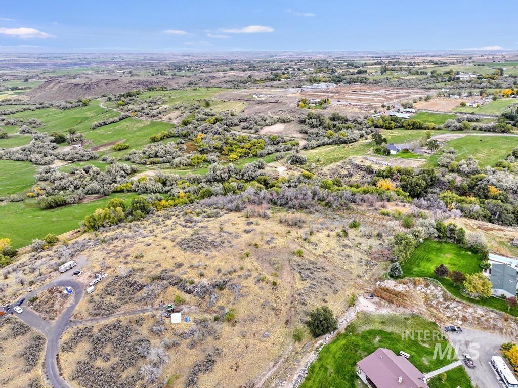 Aerial view of property and surrounding area featuring rural landscape