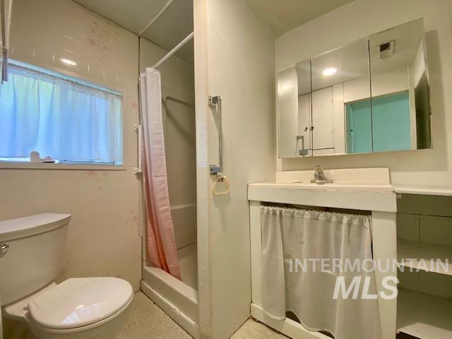 Full bathroom featuring vanity and a shower stall