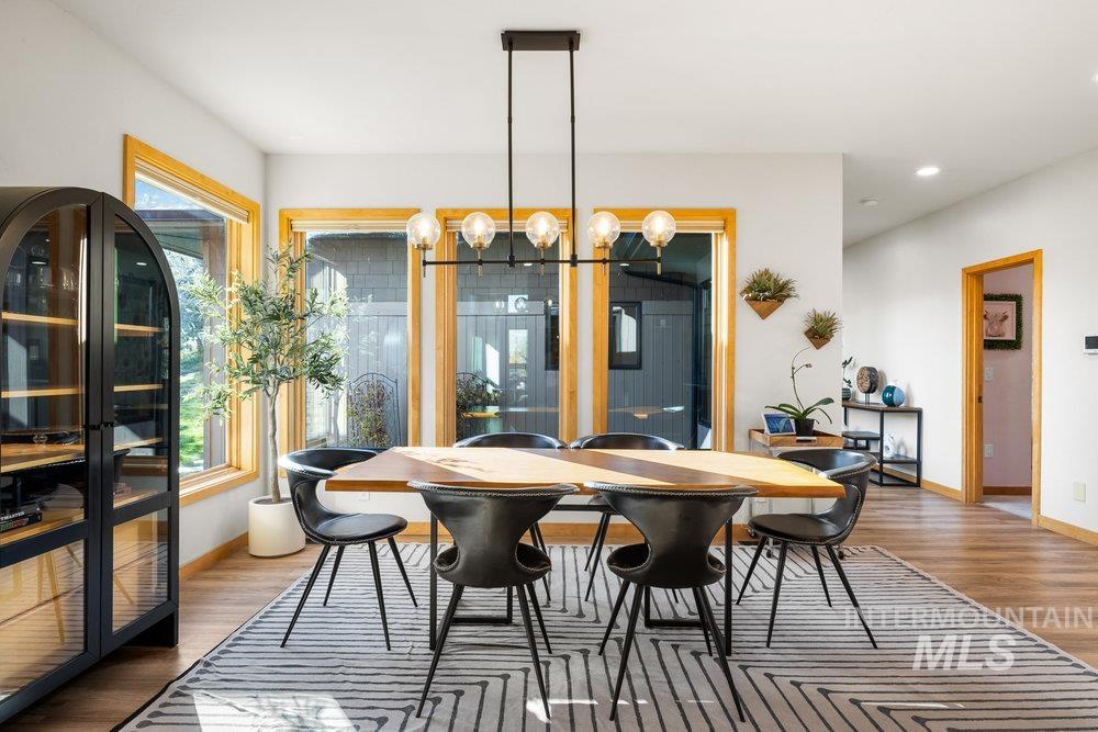 Dining room with light wood-type flooring and a chandelier