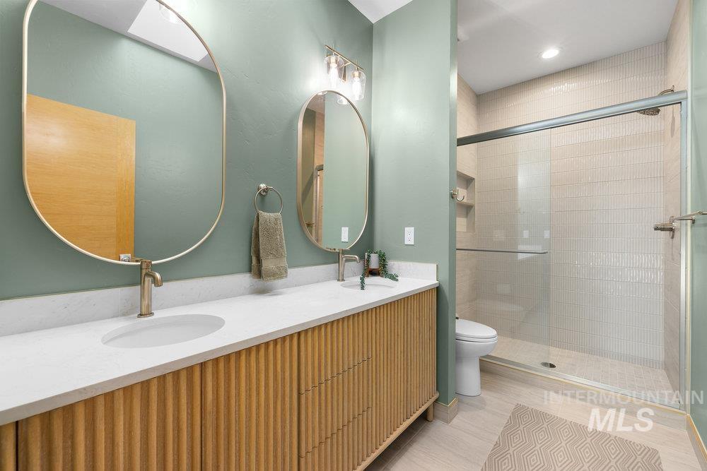 Bathroom with double vanity and a shower stall