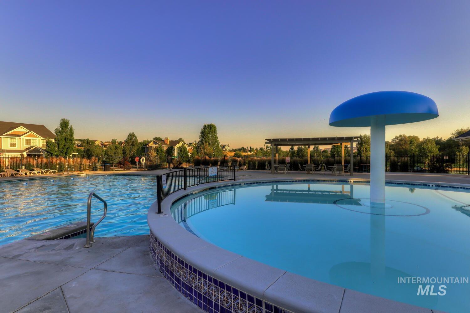 Community pool featuring a patio and a pergola