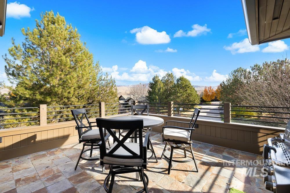 View of patio with outdoor dining area and area for grilling