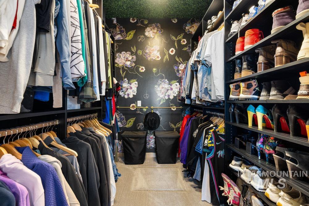 Spacious closet with light colored carpet