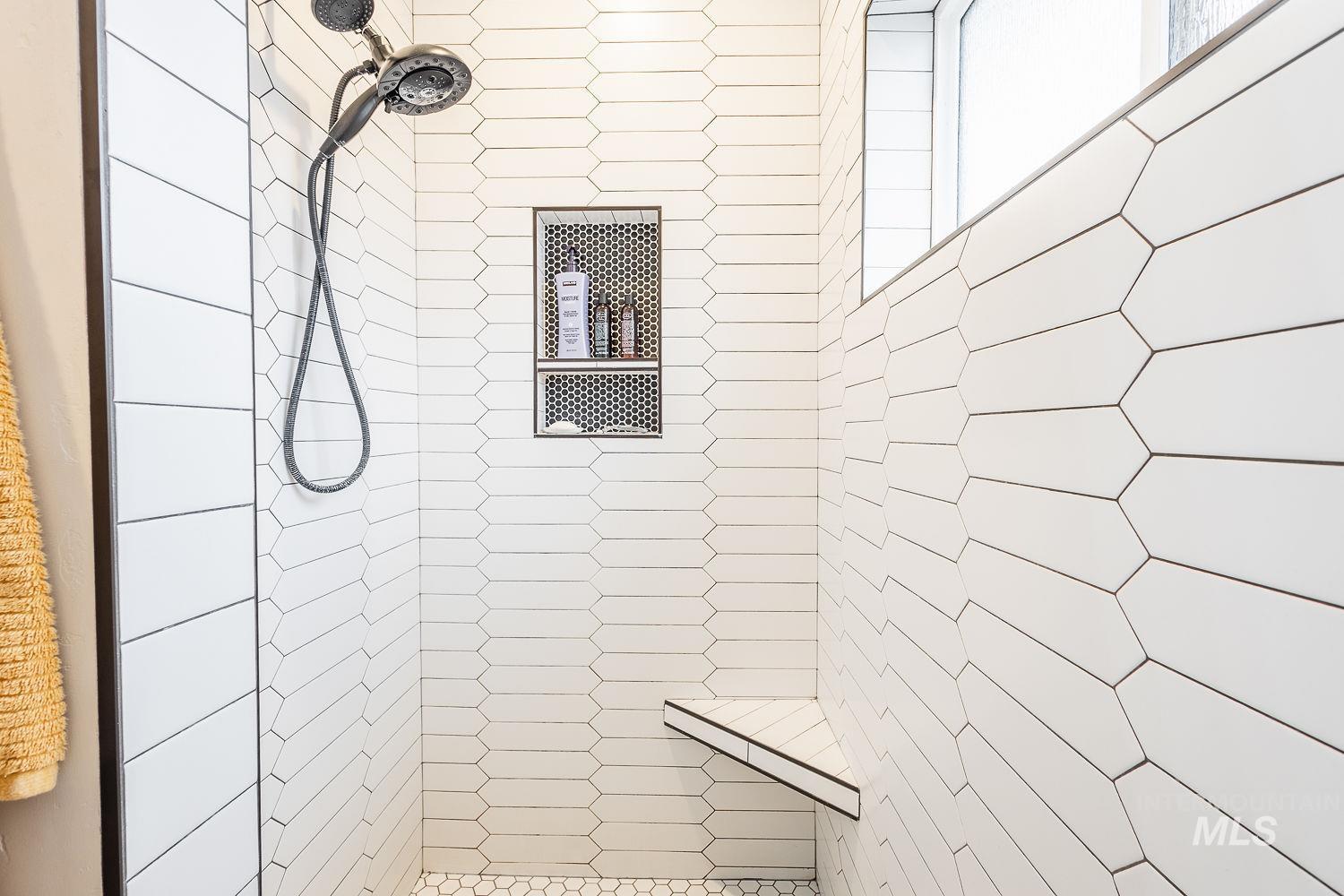 Full bathroom featuring tiled shower