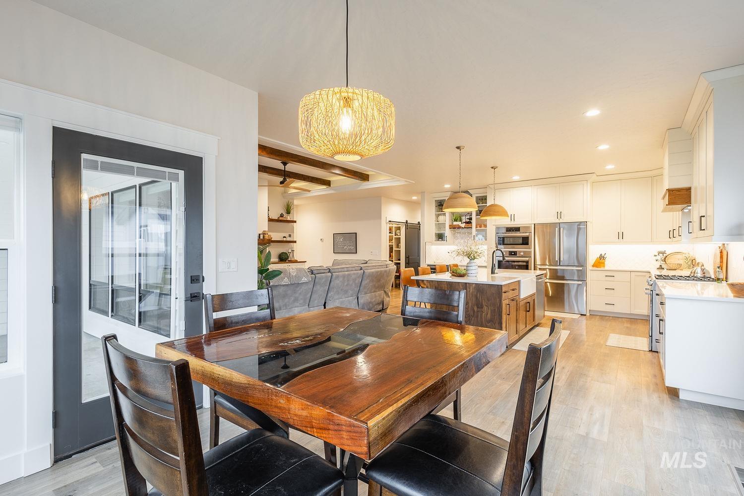 Dining room featuring light wood-style flooring and recessed lighting