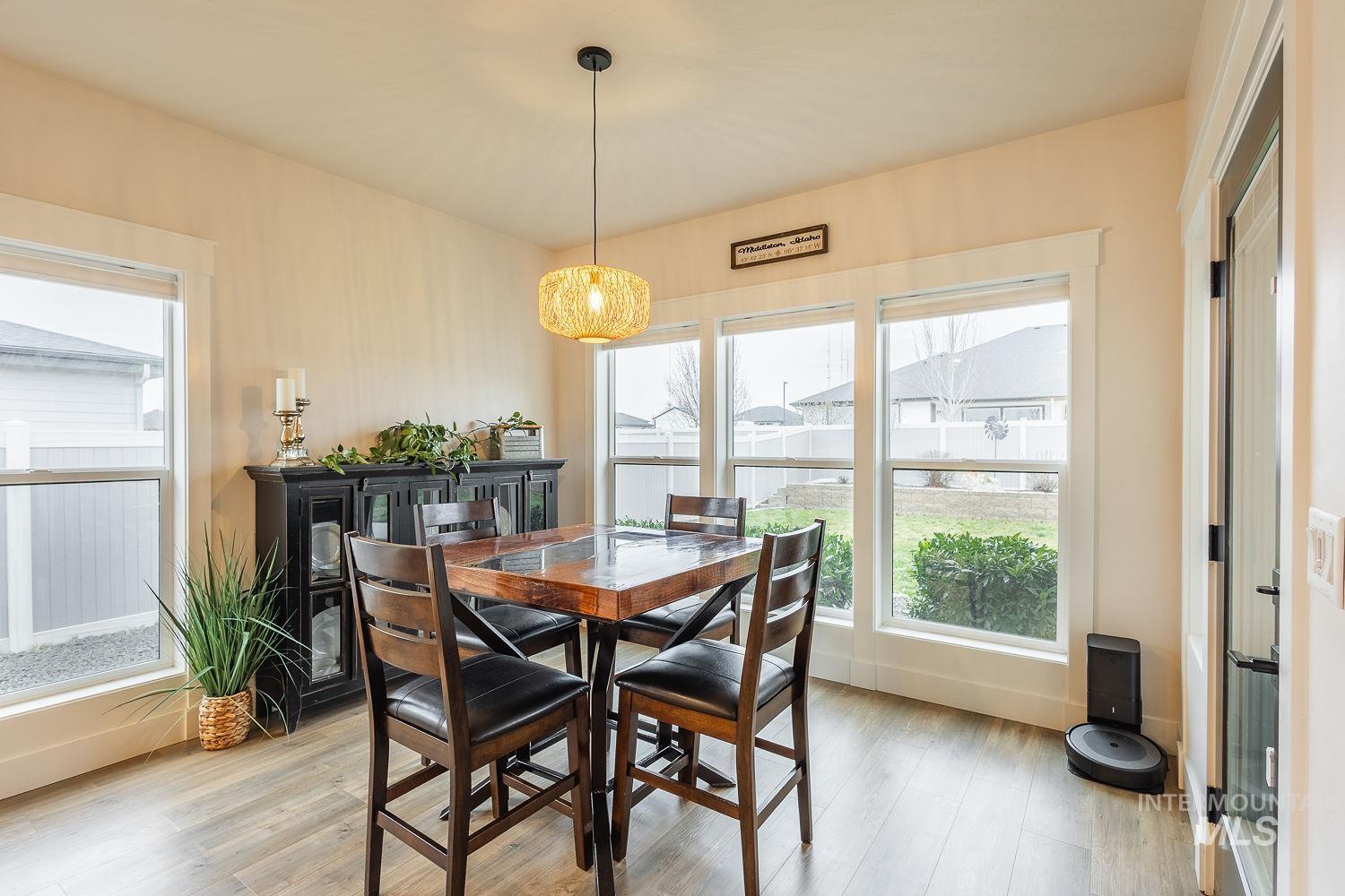 Dining space with light wood-style flooring and plenty of natural light