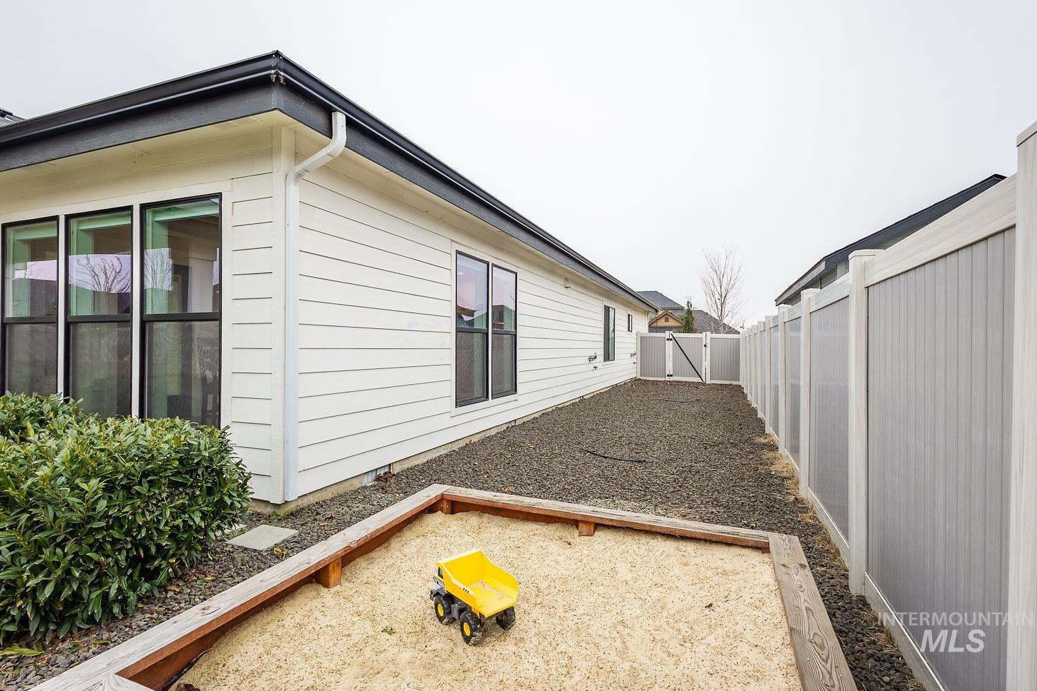 View of property exterior featuring a fenced backyard and a gate