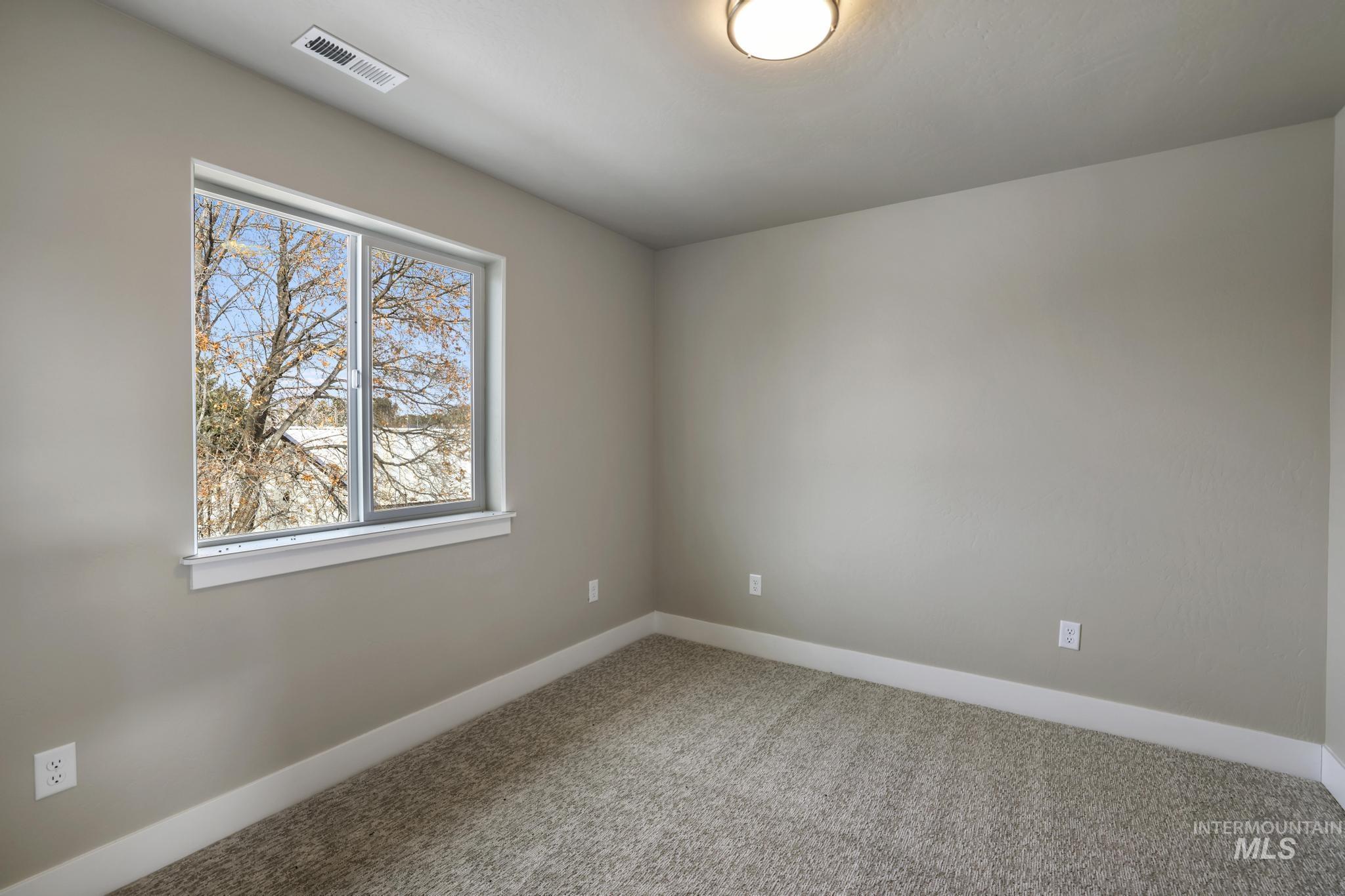 Spare room with baseboards and carpet floors