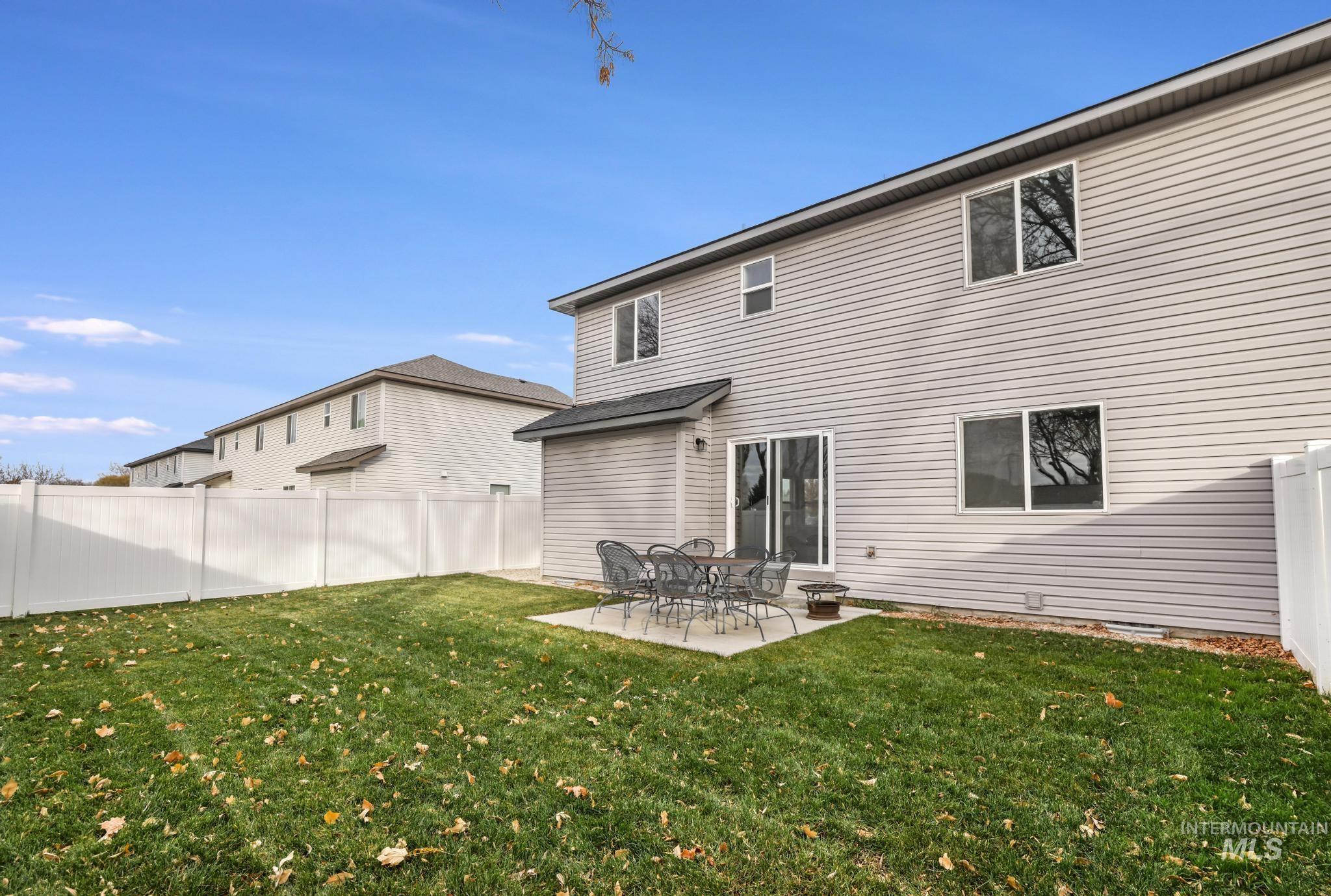 Rear view of property featuring a patio area and a fenced backyard